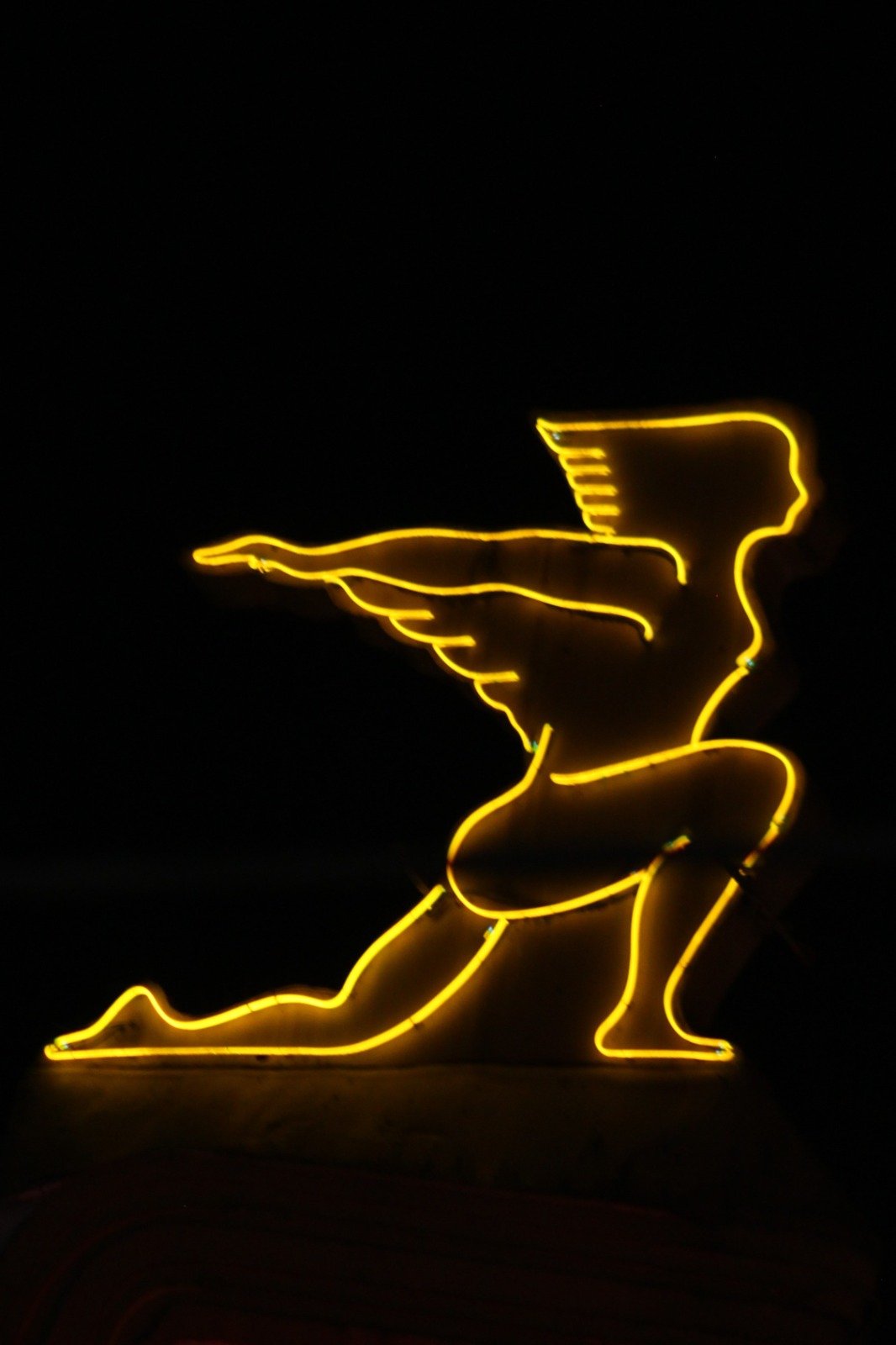 Illuminated winged figure glowing against the night in Vancouver